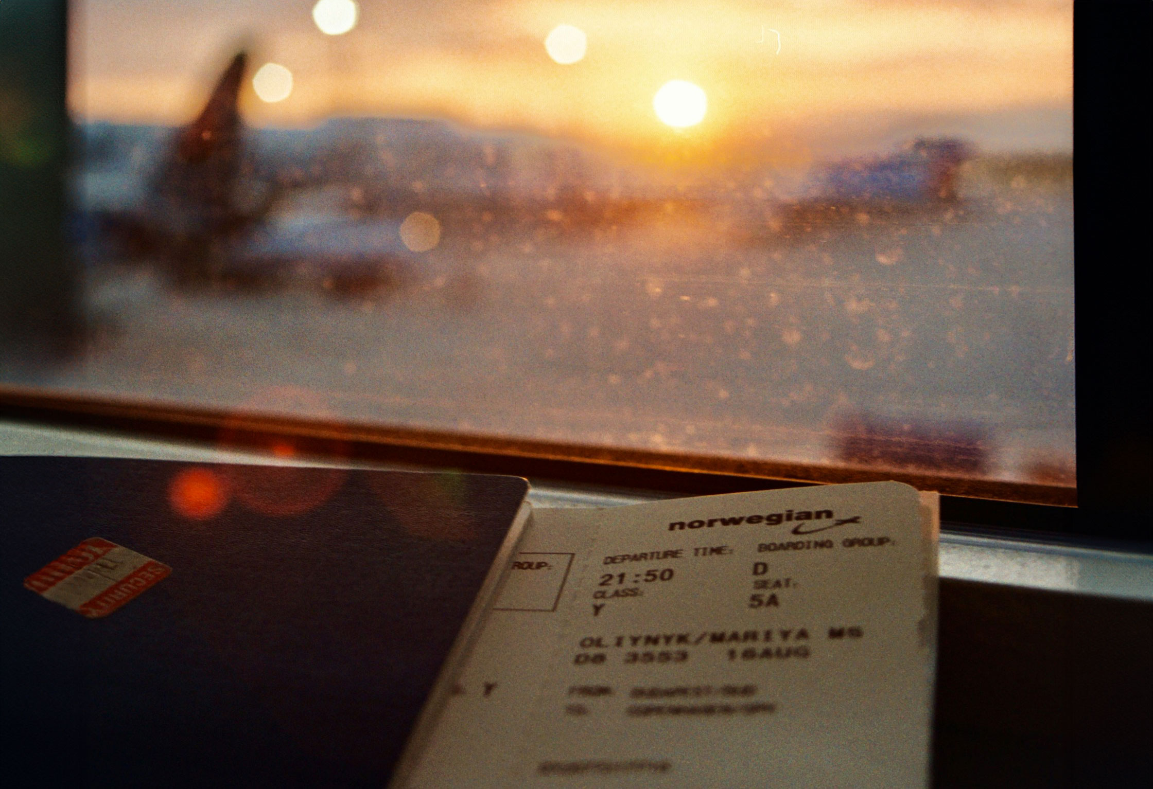 A ticket stub from an air ticket, tucked into a passport and left sitting on a table